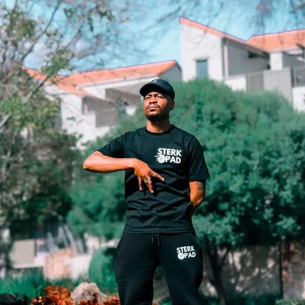 SterkOpad artist in a branded tee outside a Johannesburg house
