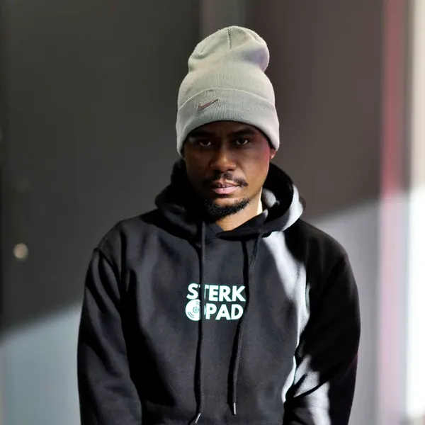 SterkOpad artist in a branded black hoodie and joggers indoors