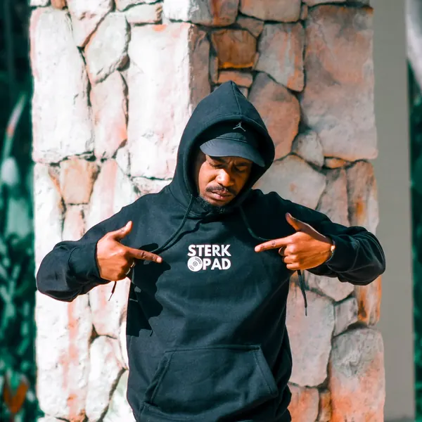 SterkOpad artist pointing to the logo on his hoodie