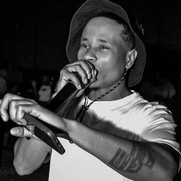 Black and white shot of an artist on the mic at night