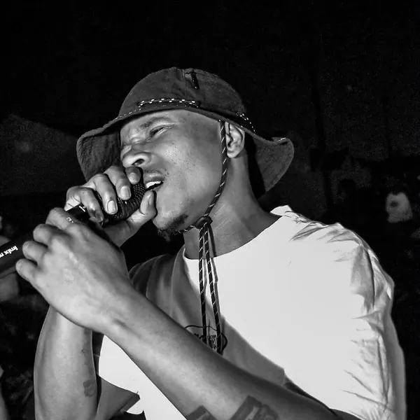 Black and white shot of an artist performing at a night event