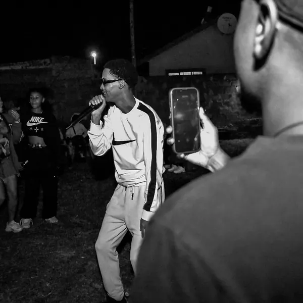 An artist performing while a phone films him
