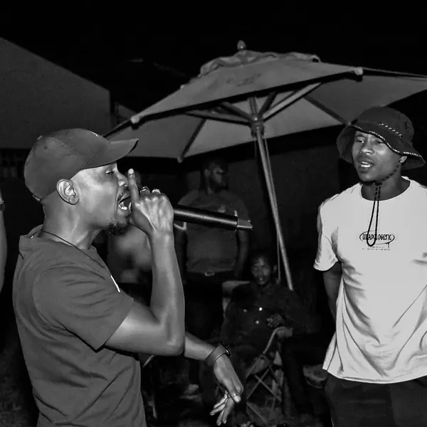 Two artists sharing the mic at a night event