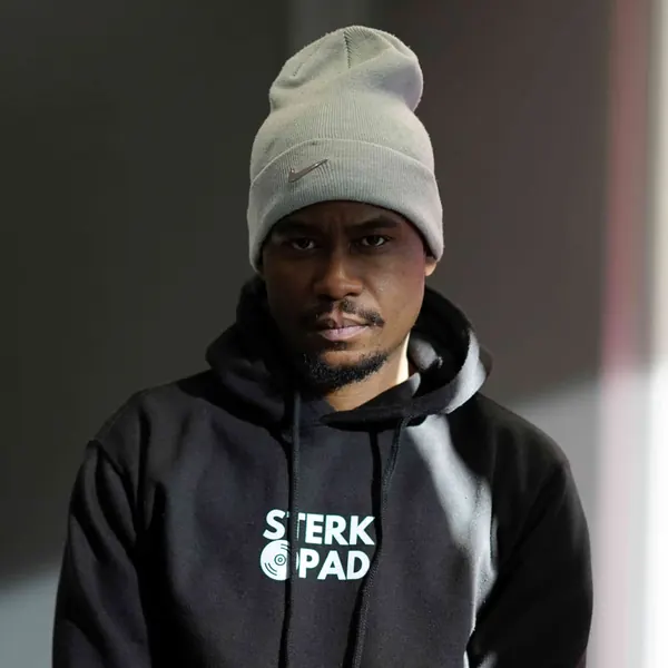 SterkOpad artist in a branded hoodie with his hands clasped