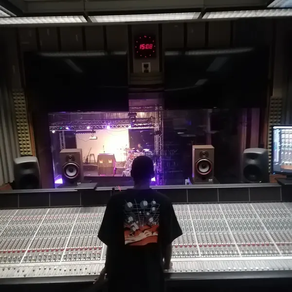 An artist at the console in a recording studio