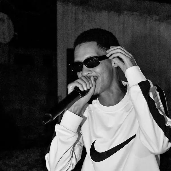 Black and white shot of an artist performing in a Nike sweater