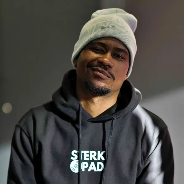 SterkOpad artist smiling in a branded hoodie and Nike beanie