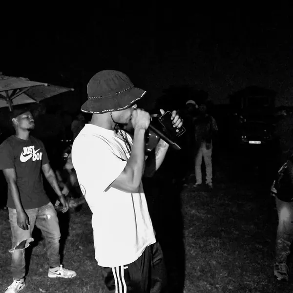 Black and white shot of an artist in a bucket hat performing