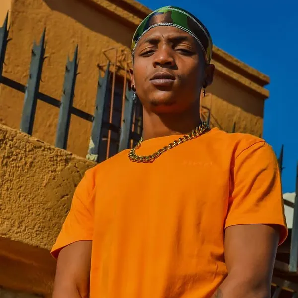 Xanny Pxxl in an orange tee and chain